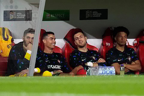 2024–25 UEFA Nations League, Portugal vs Scotland: Portugal's Cristiano Ronaldo, second from left, smiles as he sits on the bench